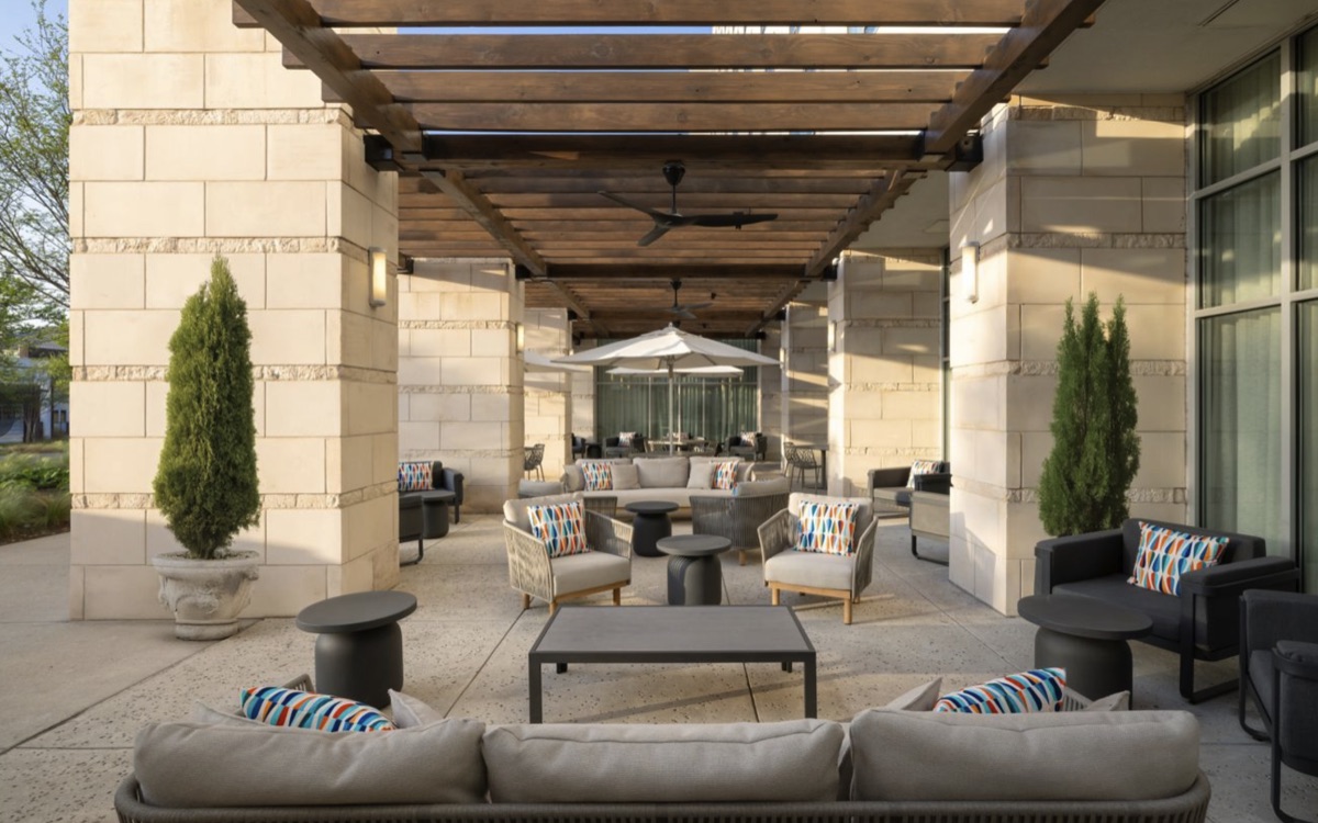 Outdoor terrace at the hotel with lounge seating under a wood pergola