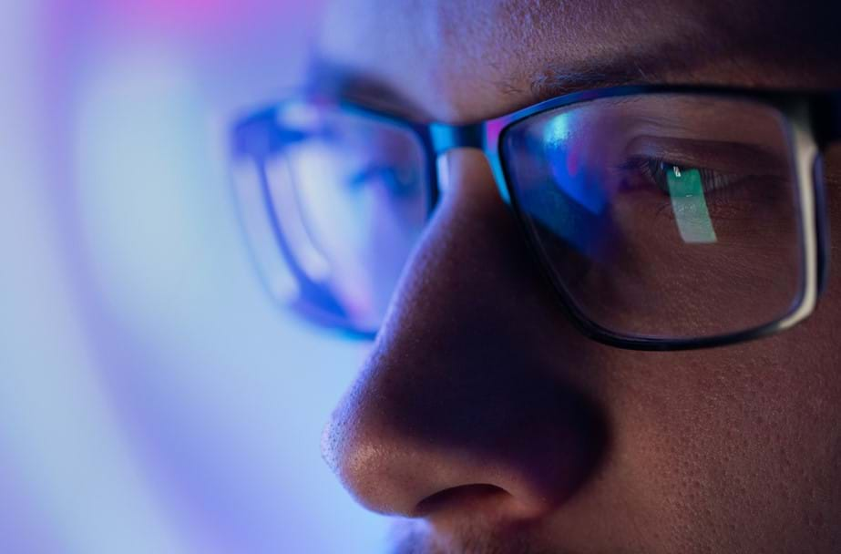 Man at a computer looking at computer screen